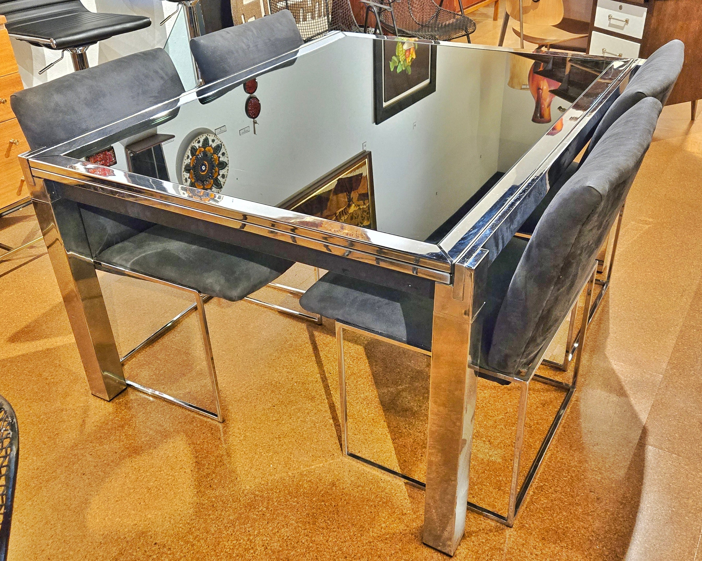 GLASS-TOP CHROMED STEEL DRAW-LEAF TABLE IN THE STYLE OF MILO BAUGHMAN