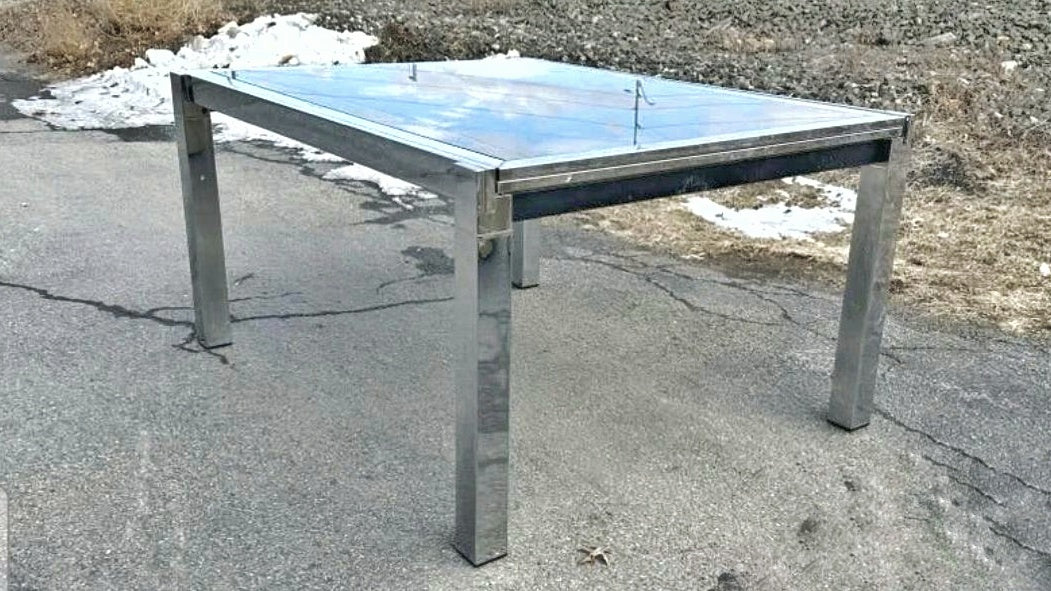 GLASS-TOP CHROMED STEEL DRAW-LEAF TABLE IN THE STYLE OF MILO BAUGHMAN